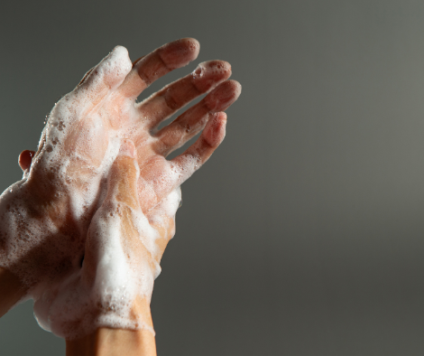 two hands lathered with soap washing demonstrating hand hygiene.